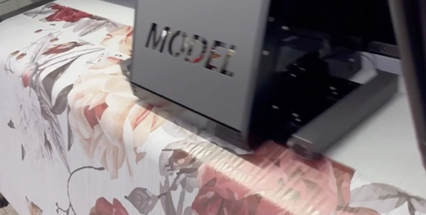 Zouhir NYC Group State-of-the-art textile printer prints a floral design on silk charmeuse fabric